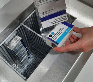Hand placing a product inside the TempArmour Vaccine Freezer (Model BFFV15)