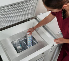 Load image into Gallery viewer, Nurse placing a product inside the TempArmour Vaccine Freezer (Model BFFV15)