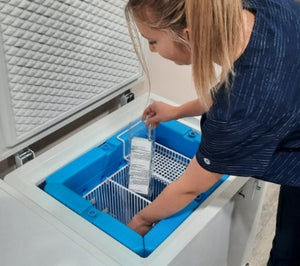 Nurse removing products from the TempArmour Vaccine Refrigerator (Model BFRV36)